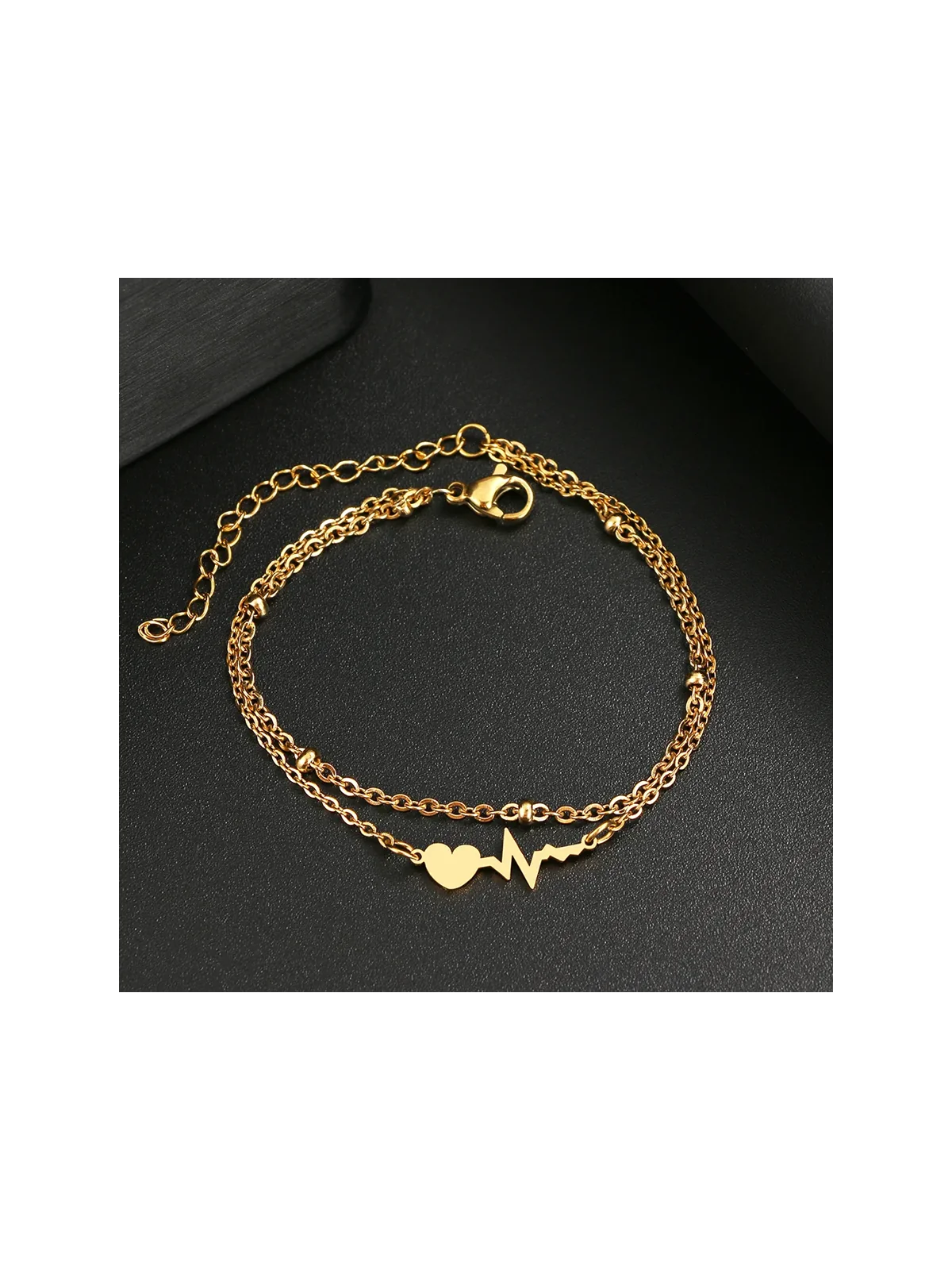 Pulsera dorada con cardiograma y corazon